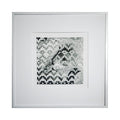 The artwork 'Afternoon Light' by Kiana Honarmand features a black and white abstract geometric composition with pixelated patterns and mosaic-like elements. The hand-cut and woven giclee prints create a dynamic interplay of light and shadow, with scattered pixel blocks forming an intricate landscape-inspired design, framed in crisp white matting. By Kiana Honarmand.