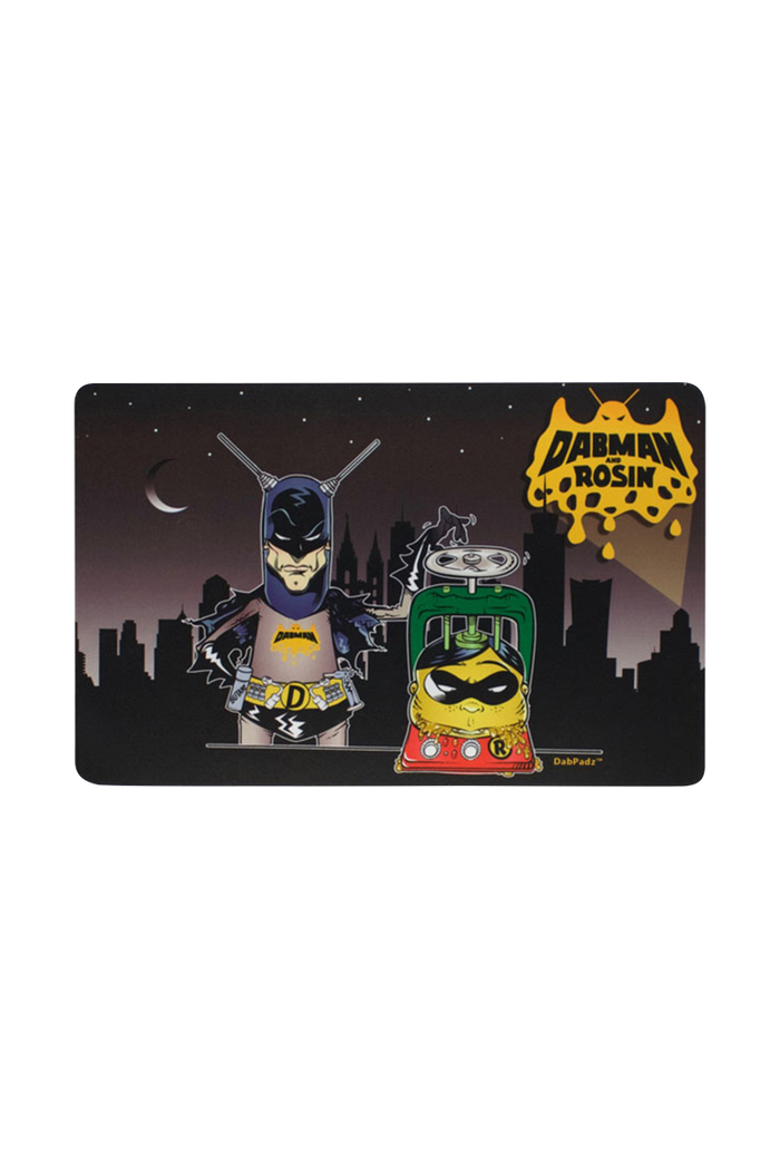 Overhead view of the DabPadz "Dabman & Rosin" Dab Mat, featuring a colorful graphic design on a flat surface.