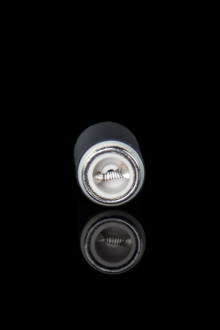 Close-up of a cannabis oil cartridge with a reflective surface.
