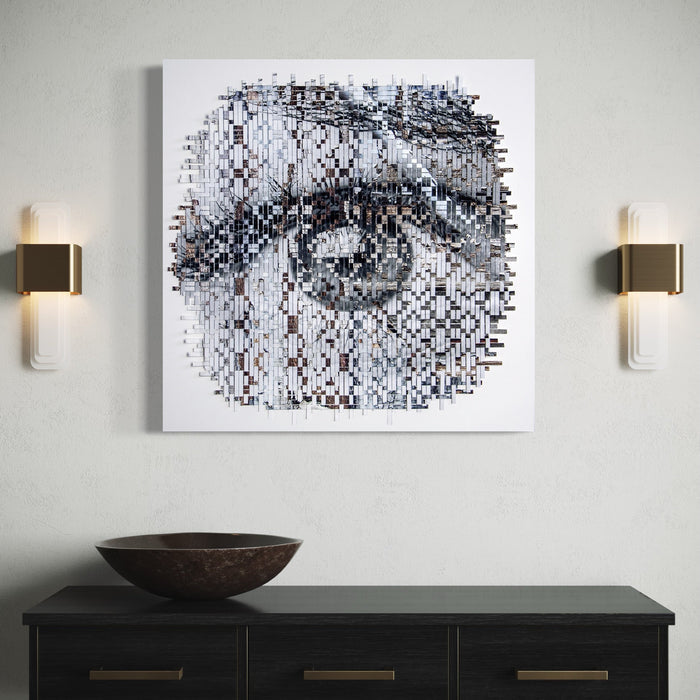Faded Glory by Kiana Honarmand: A striking pixelated monochromatic artwork featuring a close-up eye composition created through hand-cut and woven giclee prints. The image fragments into a mosaic-like pattern of black, white, and gray squares, creating a deconstructed yet recognizable ocular study measuring 28x28 inches. The geometric abstraction combines digital aesthetics with traditional weaving techniques.