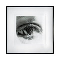 The artwork 'Fracture' by Kiana Honarmand features a striking monochromatic photographic composition of an eye rendered in a pixelated, grid-like pattern. The black and white hand-cut and woven giclee print creates a fragmented, distorted effect, with intricate details highlighting light and shadow. The piece is displayed in a minimalist black frame against a white background.