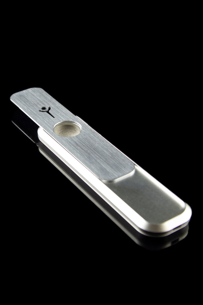 Silver pipe for smoking cannabis, studio shot on black.