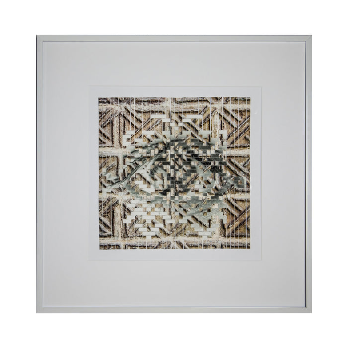 The artwork 'Geometric Clash' by Kiana Honarmand features intricate hand-cut and woven giclee prints arranged in a complex geometric pattern. Angular shapes and lines create a mesmerizing central motif in muted browns and grays, framed against a white mat in a modern silver frame. The layered design combines traditional geometric patterns with contemporary artistic techniques.