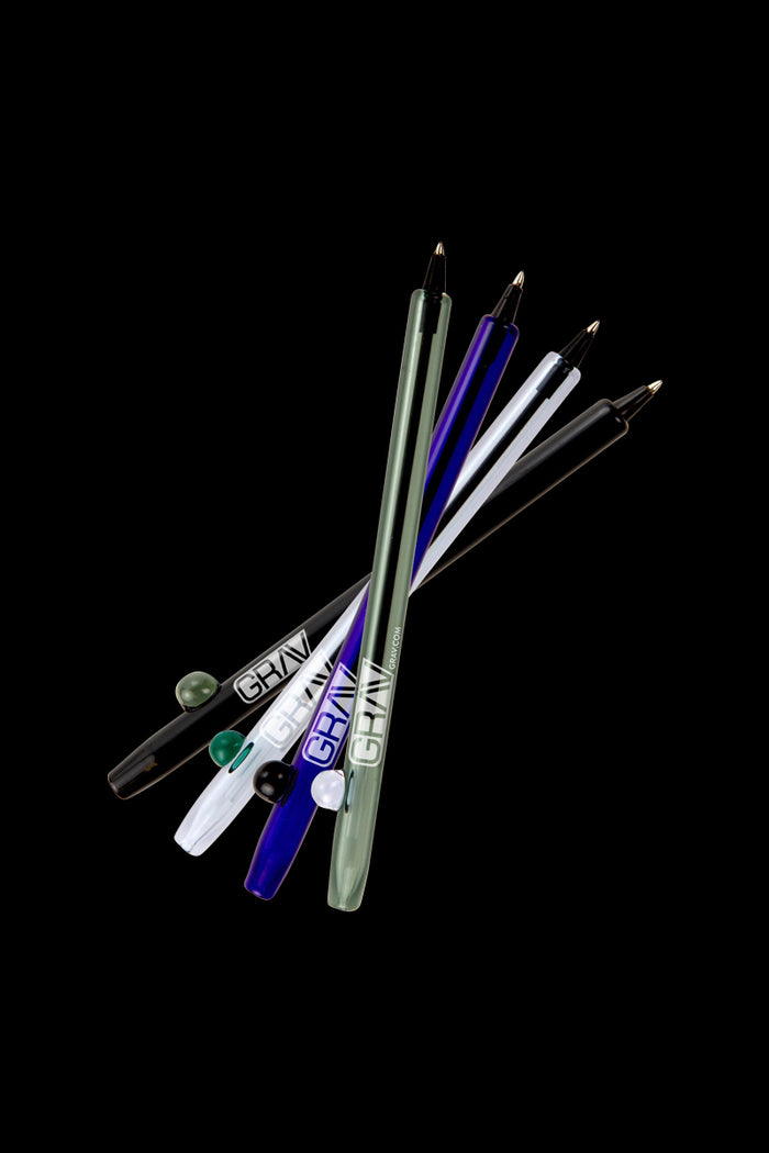 A diagonally angled studio shot of the GRAV® Boro Writing Pen pack, showcasing a collection of clear and colored pens.
