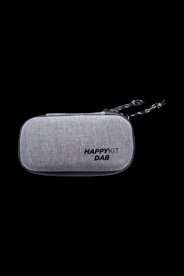 Front view of The Happy Dab Kit, a compact, textured case with a zipper closure and black pull tab.