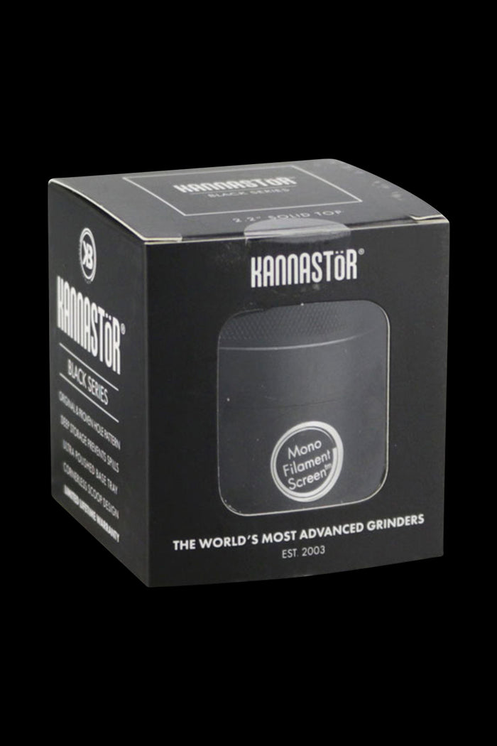 Front view of the Kannastor Multi Chamber 4pc 2.2" Grinder, showcasing its multi-tiered metal design against a dark background.