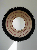 This conceptual mirror redefines Kerala's Pooram festival accessory in a contemporary, aesthetic style. Handcrafted with cotton yarn and sea shells, it creates a captivating focal point in any interior.