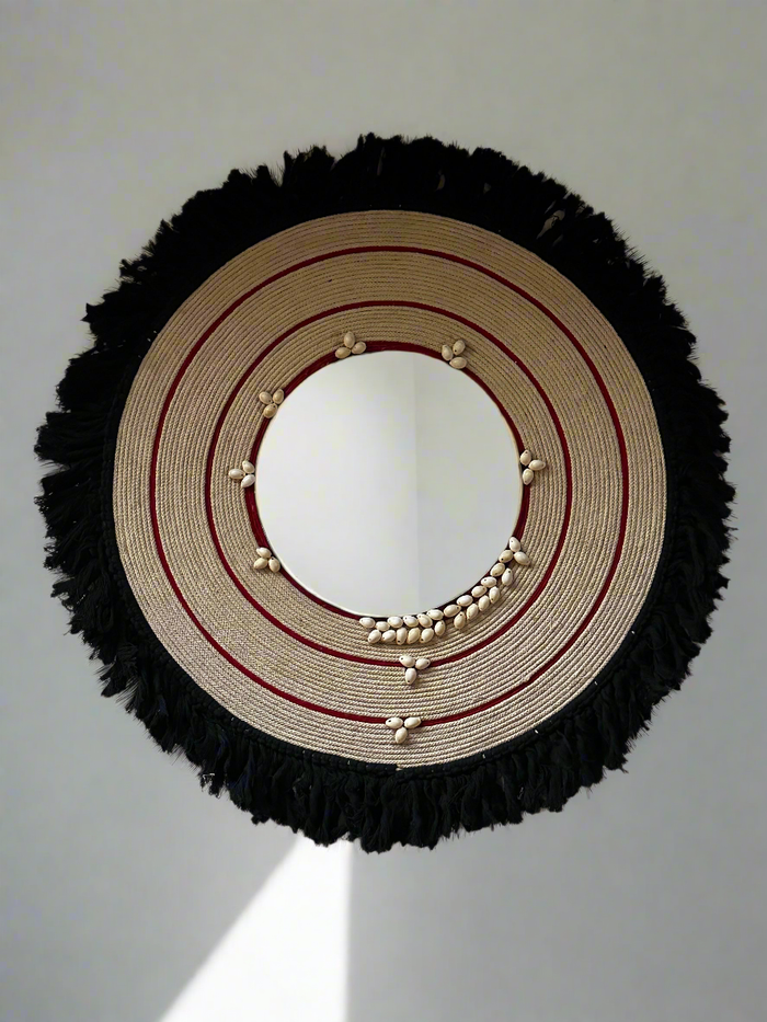 This conceptual mirror redefines Kerala's Pooram festival accessory in a contemporary, aesthetic style. Handcrafted with cotton yarn and sea shells, it creates a captivating focal point in any interior.