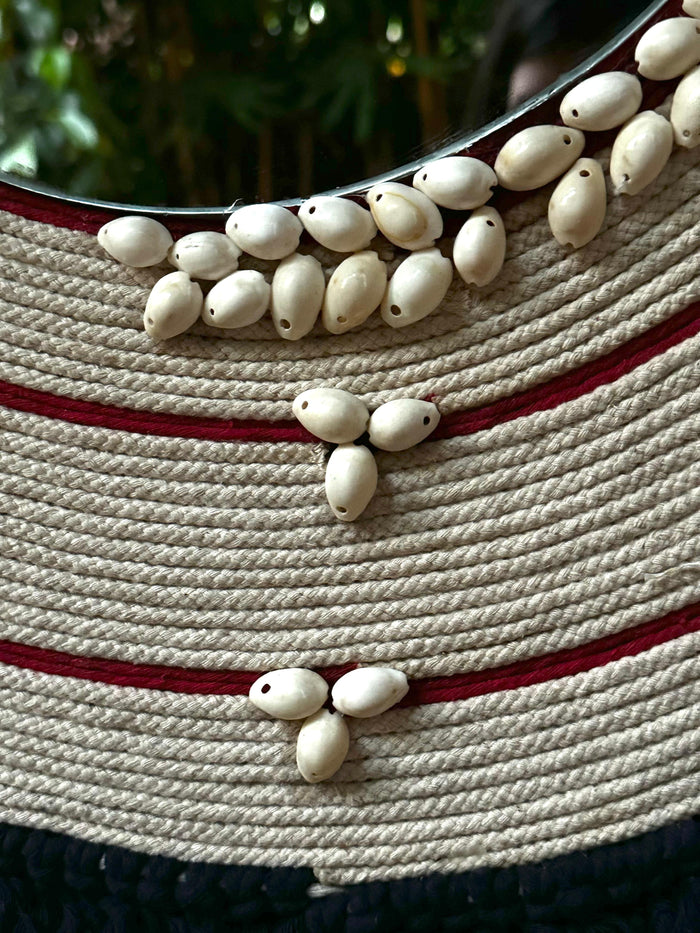 Handcrafted with cotton yarn and sea shells, it creates a captivating focal point in any interior.