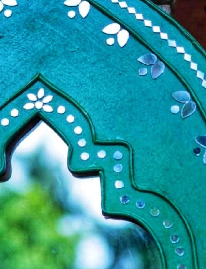 This product combines traditional Kutch Mural art with British geometric techniques and features a looking mirror at the center.