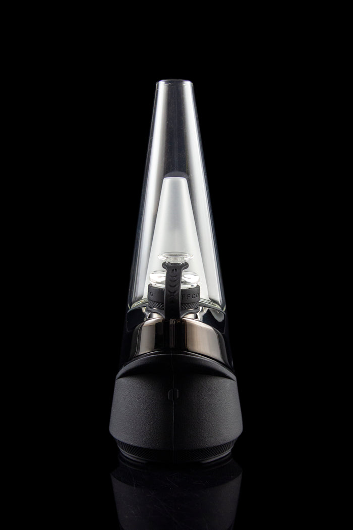 Black and clear glass dab rig with visible heating element, studio shot.