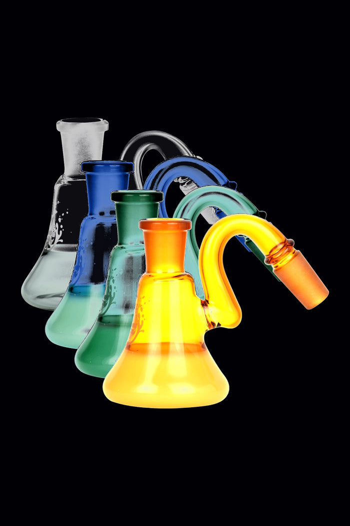 Angled front view of five Pulsar 2 Tone Ash Catcher pieces fanned across a black background, each in progressively translucent colors from gray to blue, green, and bright amber.