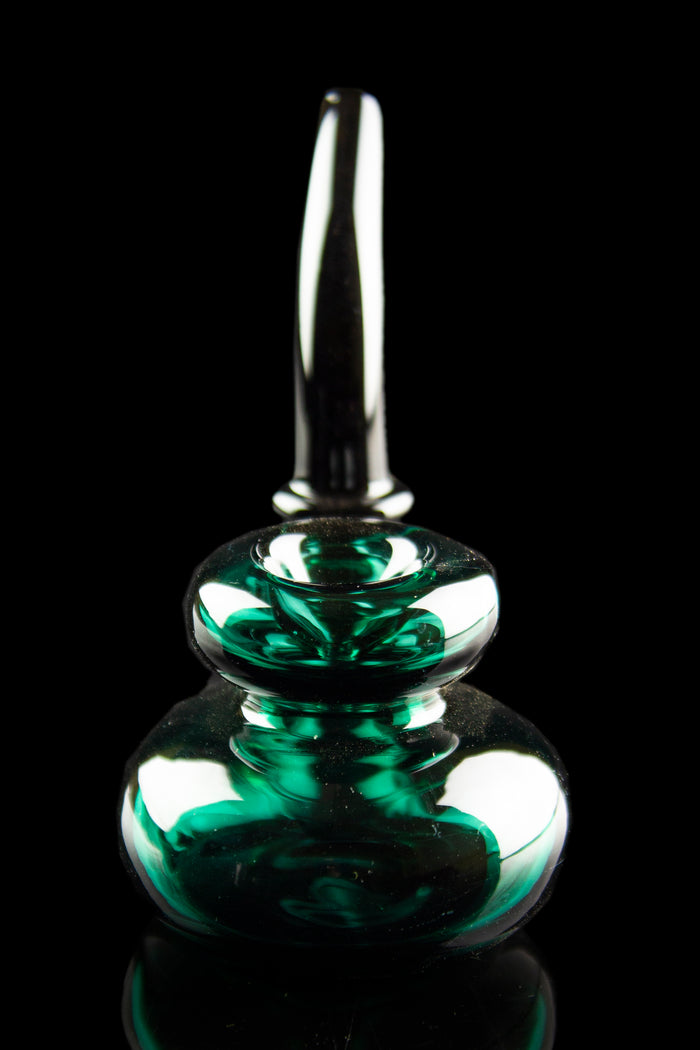 Emerald green glass oil rig with a bubbler design, isolated on black.