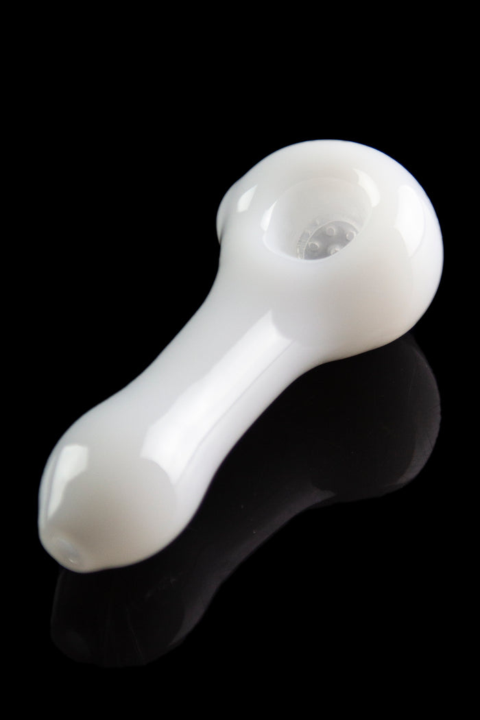White glass smoking pipe with a glossy finish and reflection on a black surface.