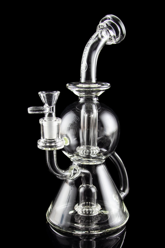 Clear glass water pipe (rig) with intricate bubbler design, isolated on black.