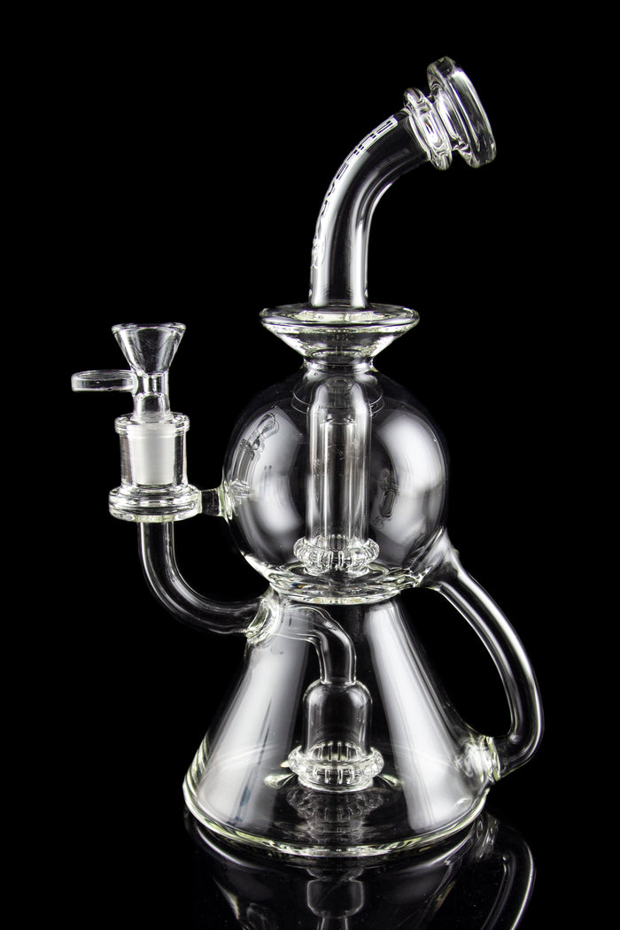 Clear glass water pipe (rig) with intricate bubbler design, isolated on black.