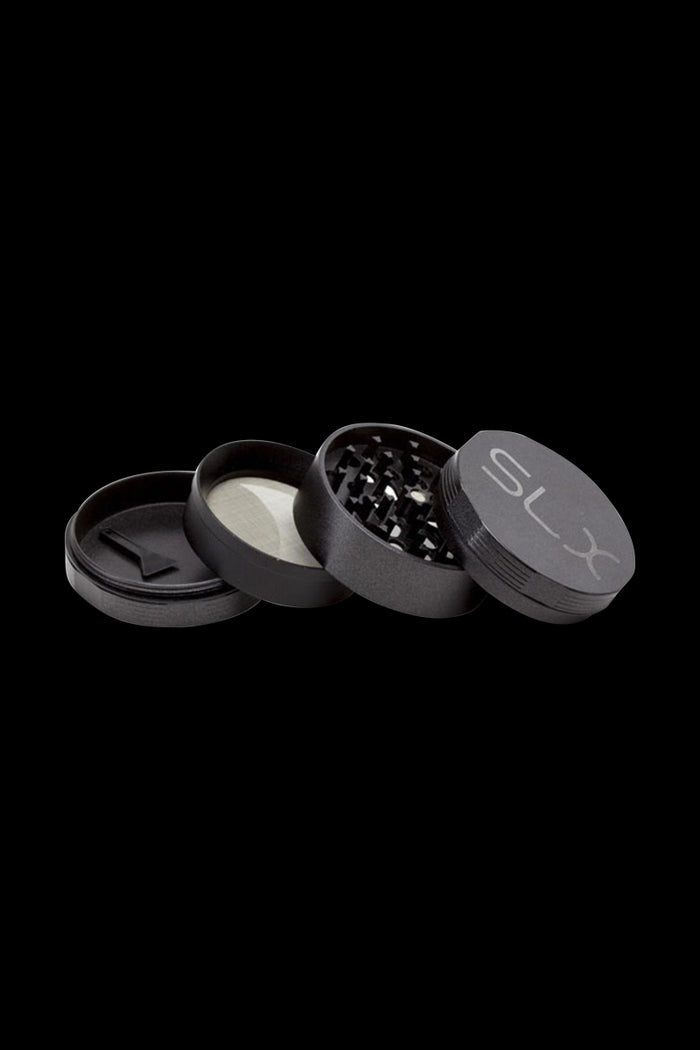 A disassembled view of the SLX Ceramic Coated 2.5" Medium Grinder, showing its metallic components and internal grinding teeth.