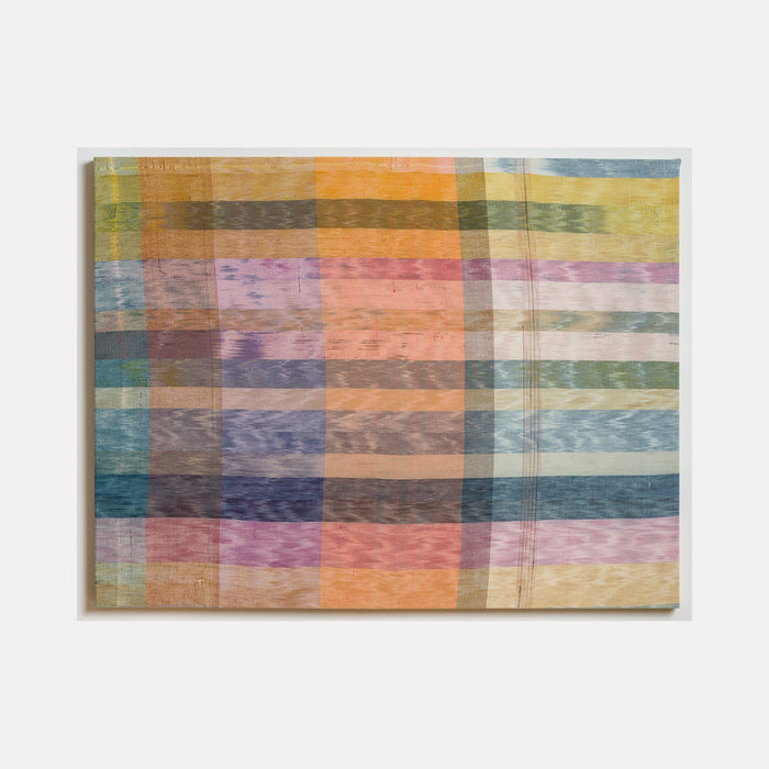 The artwork 'Untitled 155' by Victoria Manganiello features an abstract grid pattern in muted pastel colors, combining blues, pinks, oranges, and yellows. The woven textile piece creates a plaid-like effect with overlapping translucent stripes, showcasing natural and synthetic fibers with a watercolor-like quality in a 40x52 inch format.