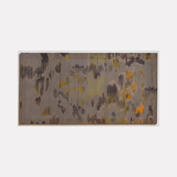 Untitled 8 by Victoria Manganiello features abstract patterns in muted gray tones with scattered golden yellow and orange accents, created using natural and synthetic fibers. The composition suggests a watercolor-like effect with organic shapes flowing across the 58x30 inch textile surface, blending dyed materials in a contemporary abstract style.