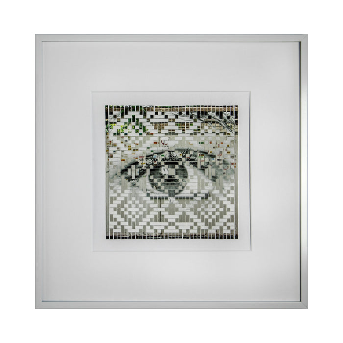 The artwork 'Warning' by Kiana Honarmand features a striking mosaic-style composition depicting an eye created through hand-cut and woven giclee prints. The pixelated pattern combines black, white, and subtle green tones in a geometric arrangement, creating a digital aesthetic within a clean white frame. The eye motif emerges from a checkered pattern with 16x16 inch dimensions.